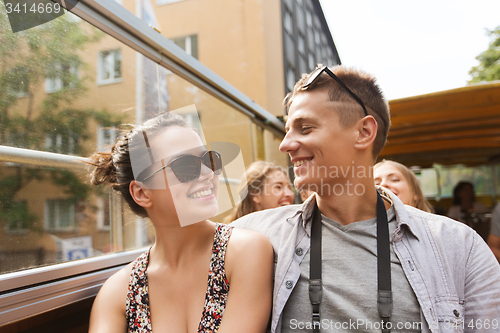 Image of smiling couple traveling by tour bus