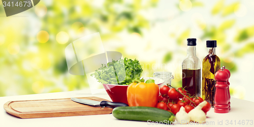 Image of vegetables, spices and kitchenware on table