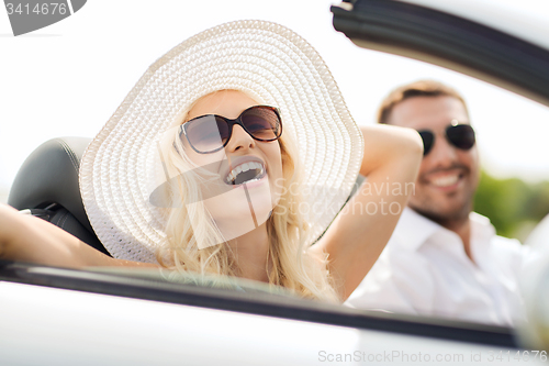 Image of happy man and woman driving in cabriolet car