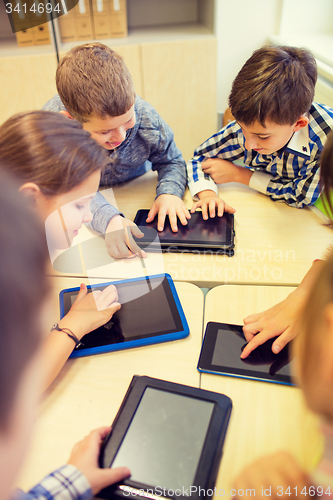 Image of group of school kids with tablet pc in classroom