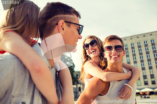 Image of smiling couple having fun in city