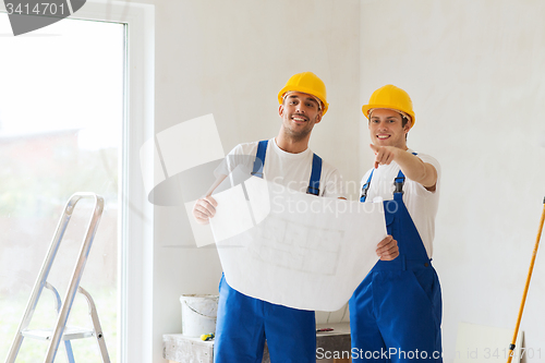 Image of group of builders with blueprint