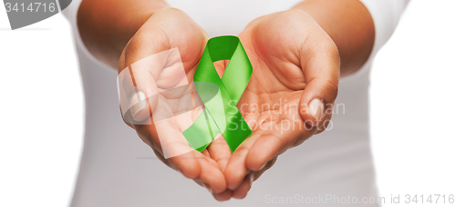 Image of hands holding green awareness ribbon