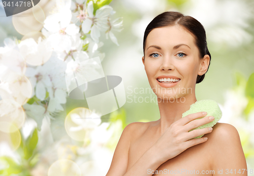 Image of woman with sponge over cherry blossom background