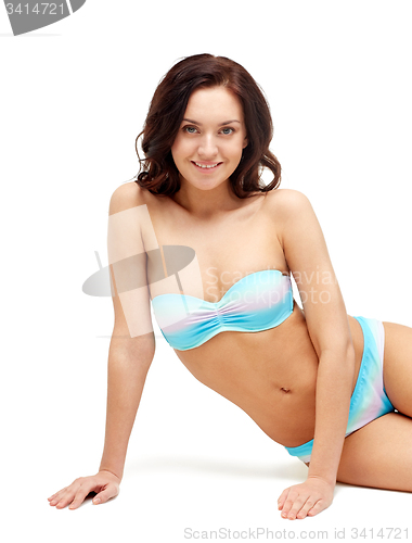 Image of happy young woman sunbathing in bikini swimsuit