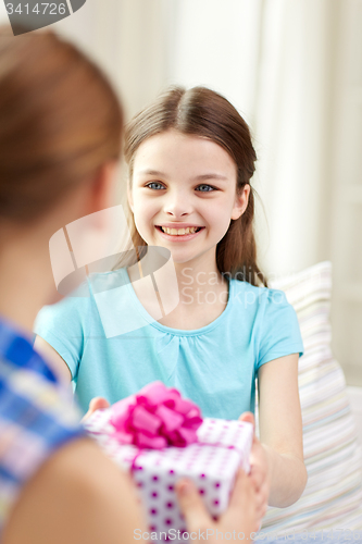 Image of happy little girls with birthday present at home