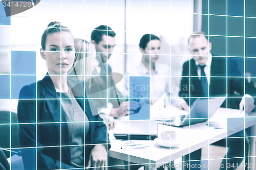 Image of businesswoman and business team at office the back