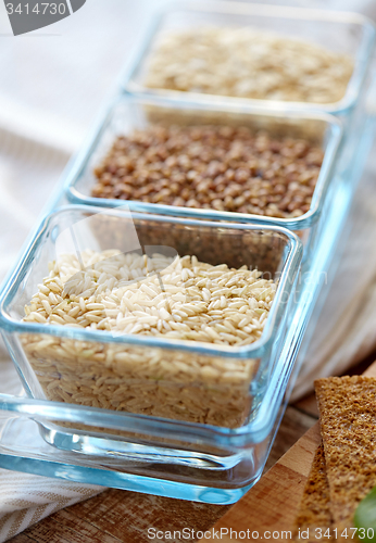 Image of close up of grain in glass bowls on wooden table