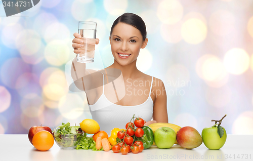 Image of happy woman with healthy food showing water glass