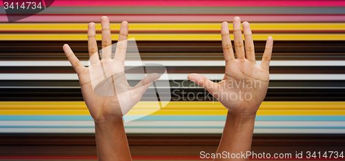 Image of two african hands making high five over blue sky