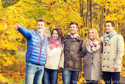 Image of group of smiling men and women in autumn park