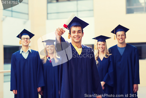 Image of group of smiling students in mortarboards