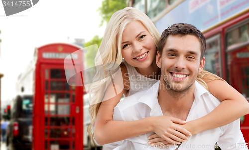 Image of happy couple hugging over london city street