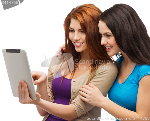 Image of two smiling teenagers with tablet pc computer