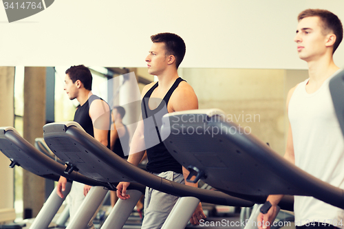 Image of group of men exercising on treadmill in gym