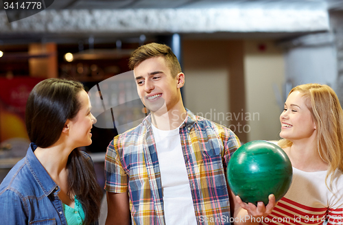 Image of happy friends in bowling club