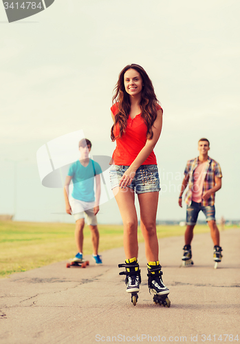 Image of group of smiling teenagers with roller-skates