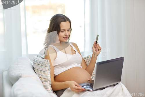 Image of pregnant woman with laptop and ultrasound image