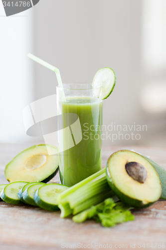 Image of close up of fresh green juice glass and vegetables