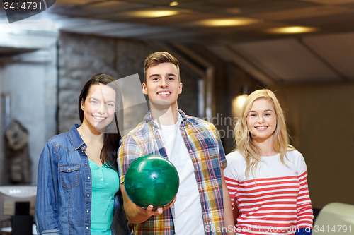 Image of happy friends in bowling club