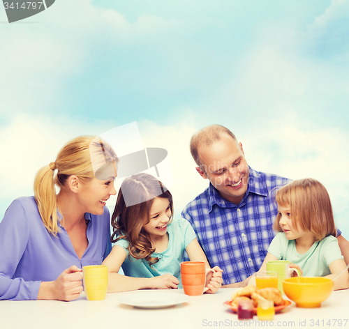 Image of happy family with two kids with having breakfast