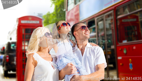 Image of happy family in sunglasses over london city street