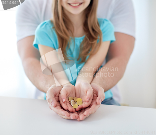 Image of close up of family hands holding euro money coins