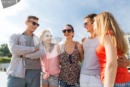 Image of group of smiling friends in city