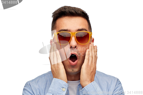 Image of face of scared man in shirt and sunglasses