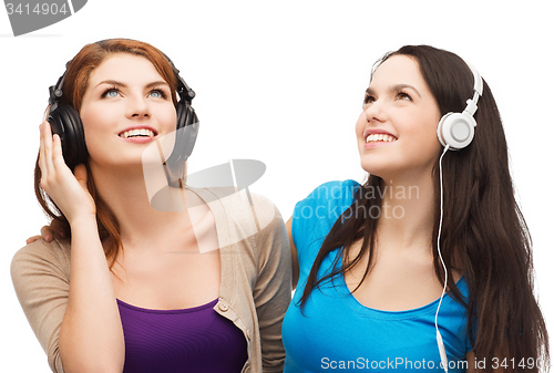 Image of two smiling teenagers with headphones