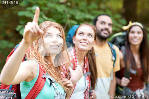 Image of group of smiling friends with backpacks hiking