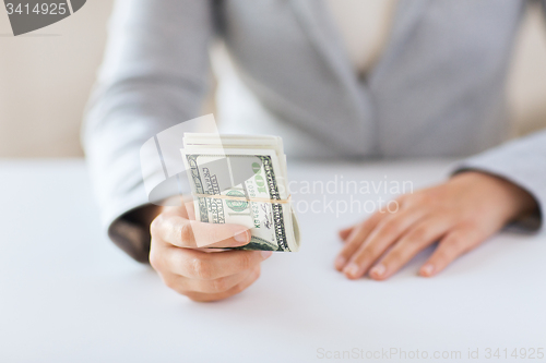 Image of close up of woman hands holding us dollar money