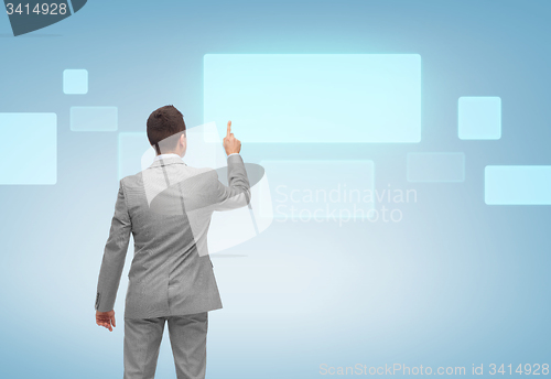 Image of businessman pointing finger to virtual screen