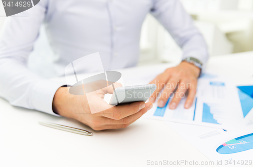 Image of close up of businessman with smartphone