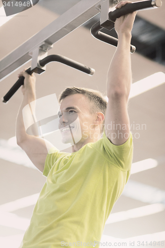 Image of smiling man exercising in gym