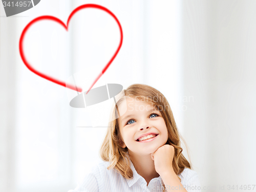 Image of smiling little student girl drawing at school