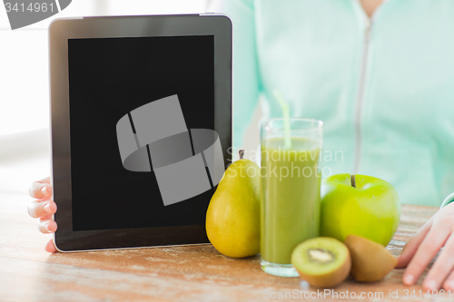 Image of close up of woman hands tablet pc and fruit juice