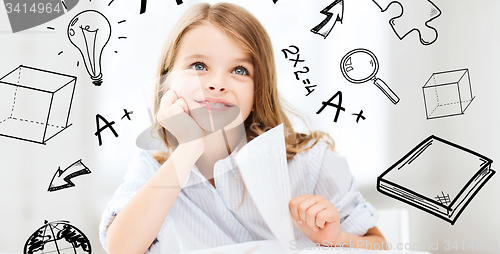 Image of little student girl studying at school