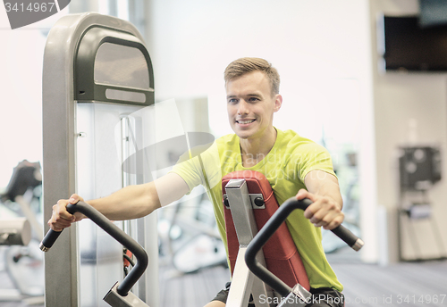 Image of smiling man exercising in gym