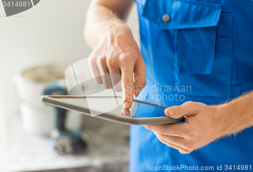 Image of close up of builder or workman with tablet pc