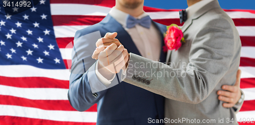 Image of close up of happy male gay couple dancing