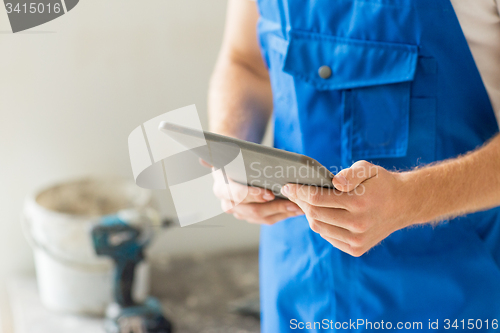 Image of close up of builder or workman with tablet pc