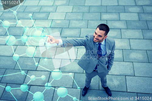 Image of young smiling businessman outdoors from top