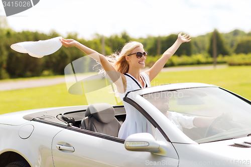 Image of happy man and woman driving in cabriolet car