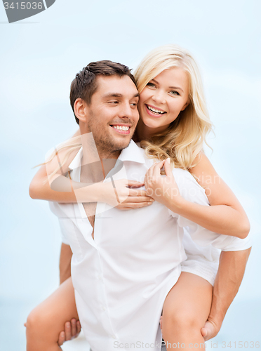 Image of couple having fun on the beach