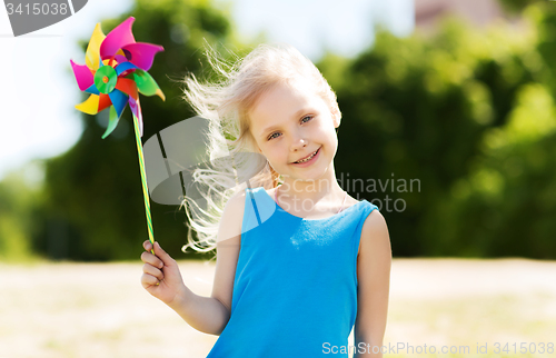 Image of happy little girl with colorful pinwheel at summer
