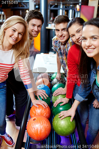 Image of happy friends in bowling club