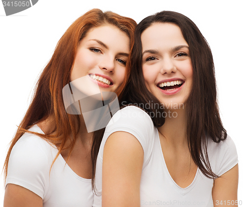 Image of two laughing girls in white t-shirts hugging