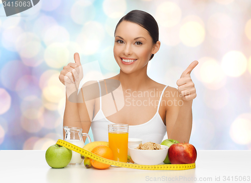 Image of happy woman with healthy food showing thumbs up