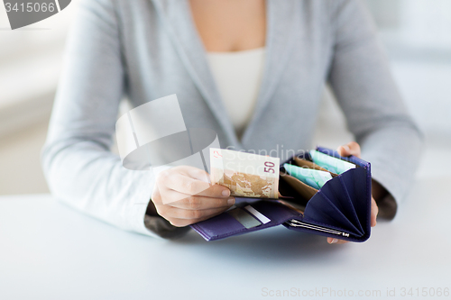 Image of close up of woman hands with wallet and euro money